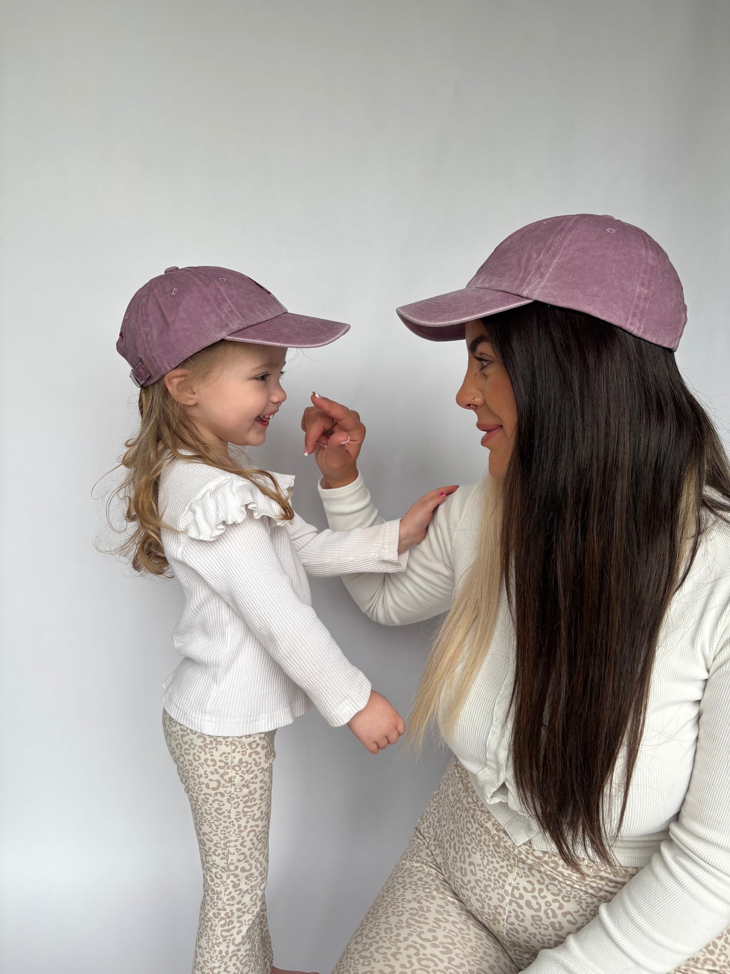 mauve baseball cap on mother and child 